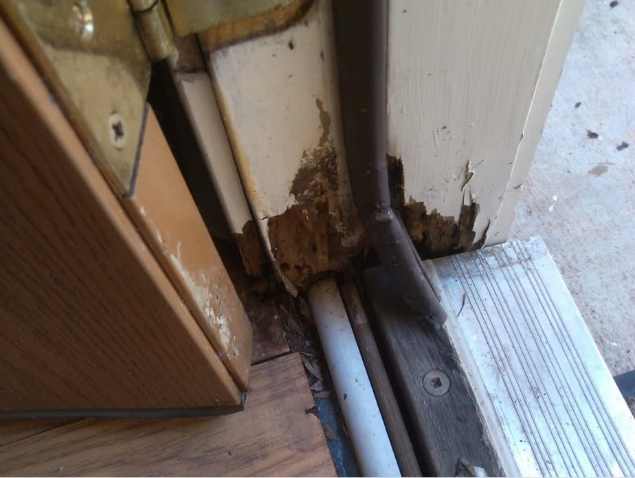 Rotted door frame and threshold before the repair