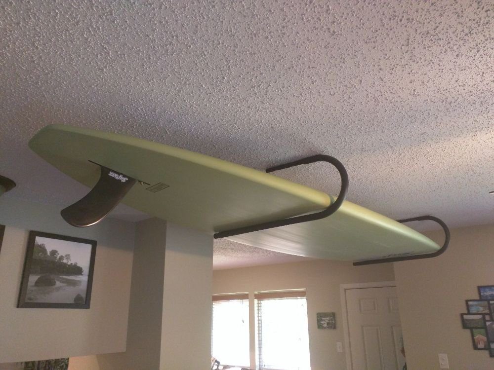 Surfboard hung from the ceiling on a steel rack